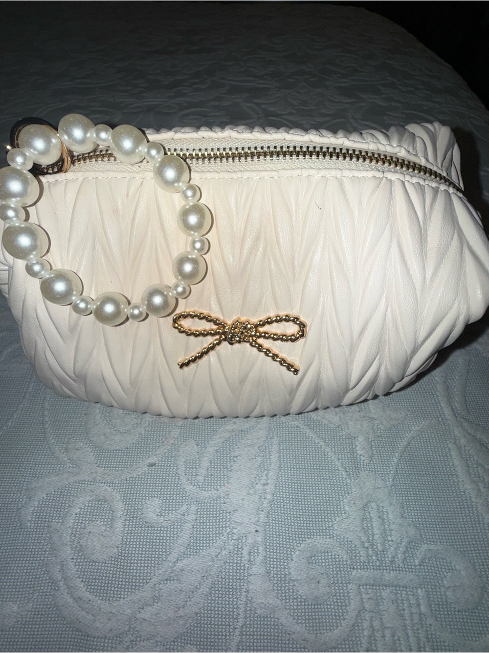 Vince Camuto Cream Pleated Cosmetic Wristlet with Pearl Handle & Gold Bow Accent